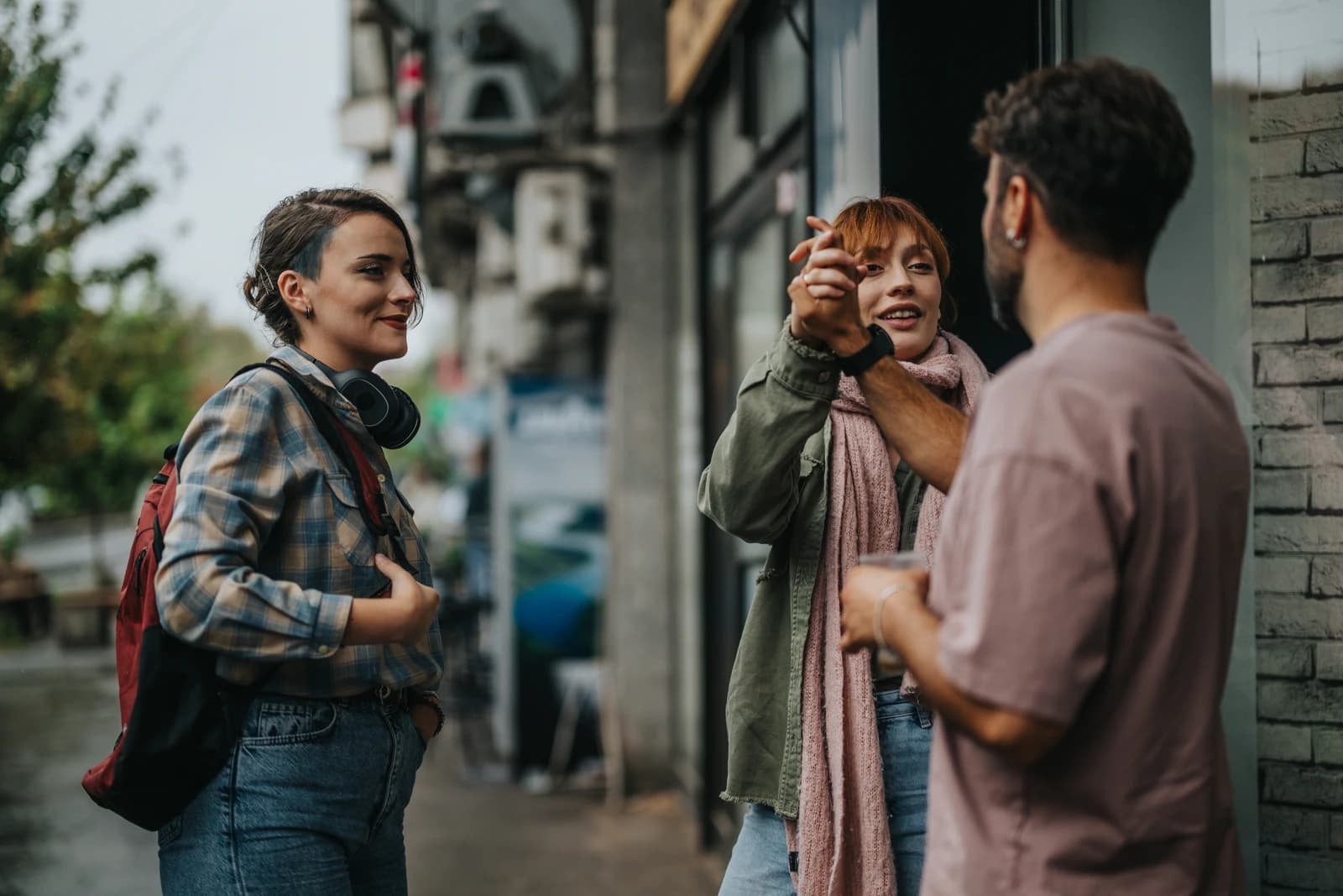 Two people talking on a San Francisco sidewalk in an unplanned street-level encounter, mid-conversation.